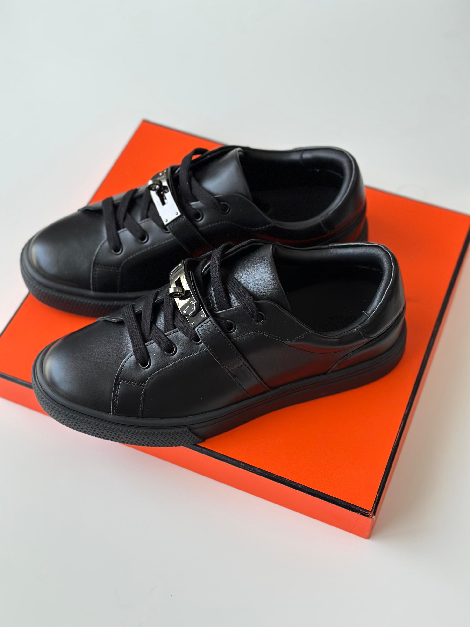 Hermès Day Sneaker in Black Calfskin with Kelly Buckle – Modern Urban Leather Sneaker.
